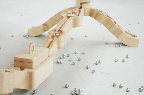 Marbelous, a wooden table with built-in marble tracks